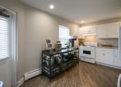Thumbnail 27 of 35 - a kitchen with white appliances and a black counter top
