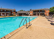 Thumbnail 13 of 41 - Outdoor swimming pool with sundeck seating at Compton Lake Apartments in Mount Healthy, Ohio