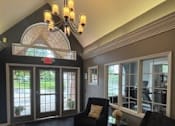 Thumbnail 74 of 74 - A living room with a black couch and a chandelier.