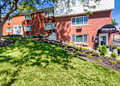 Thumbnail 63 of 71 - Leasing office exterior (at the corner of the building) with landscaped lawn at Colonial Ridge Apartments in Pleasant Ridge