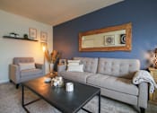 Thumbnail 14 of 62 - This is a photo of the living room of the 550 square foot 1 bedroom, 1 bath, balcony floor plan model apartment at College Woods Apartments in Cincinnati, OH.
