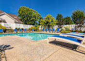 Thumbnail 55 of 82 - A pool with a white fence and blue loungers at Fairfield Pointe Apartments in Fairfield, Ohio.
