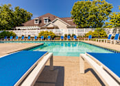Thumbnail 53 of 82 - A large blue swimming pool with a white fence by the clubhouse at Fairfield Pointe Apartments in Fairfield, Ohio.