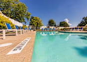 Thumbnail 54 of 82 - A pool surrounded by blue lounge chairs at Fairfield Pointe Apartments in Fairfield, Ohio.