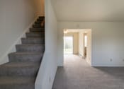 Thumbnail 25 of 56 - This is a photo of the living room and stairway in the 1004 square foot, 2 bedroom, 1.5 bath townhome floor plan at Lake of the Woods Apartments in Cincinnati, OH.