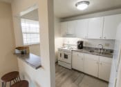 Thumbnail 16 of 56 - This is a photo of the kitchen and breakfast bar of the 1 bedroom, 631 square foot model apartment at Lake of the Woods Apartments in Cincinnati, OH.