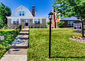 Thumbnail 52 of 59 - Leasing office exterior with front walkway and manicured lawn at Lake of the Woods Apartments in Mount Healthy