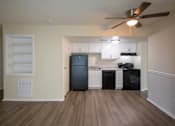 Thumbnail 14 of 73 - This is a photo of the kitchen and living room with built-in bookshelf of the 560 square foot 1 bedroom, 1 bath Elm floor plan at Montana Valley Apartments in Cincinnati, OH.