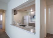 Thumbnail 12 of 70 - This is a photo the kitchen through the pass-through window in the 833 square foot, Chestnut, 2 bedroom apartment at Montana Valley Apartments in Cincinnati, OH.