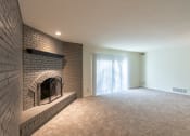 Thumbnail 29 of 70 - This is a photo the living room with brick wall and wood-burning fireplace of the 925 square foot, Hazelnut 2 bedroom, 1 bath apartment at Montana Valley Apartments in the Westwood neighborhood of Cincinnati, OH.