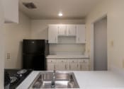 Thumbnail 9 of 70 - This is a photo the kitchen with white cabinets in the 925 square foot, Hazelnut 2 bedroom, 1 bath apartment at Montana Valley Apartments in the Westwood neighborhood of Cincinnati, OH.