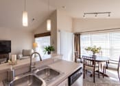 Thumbnail 147 of 147 - This is a photo of the living room and dining area from the kitchen in the 1016 square foot, 2 bedroom, 2 bath Nautica floor plan at Nantucket Apartments in Loveland, OH.