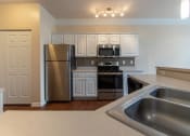Thumbnail 7 of 147 - This is a photo of the kitchen in the 1578 square foot, 3 bedroom, 2 and 1/2 bath Flagship floor plan at Nantucket Apartments in Loveland, OH.