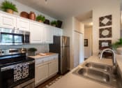 Thumbnail 2 of 147 - This is a photo of the kitchen in the 2 bedroom, 2 bath Islander floor plan at Nantucket Apartments in Loveland, OH.