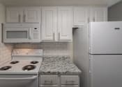 Thumbnail 6 of 62 - A kitchen with a white cabinets 1 bedroom, 1 bath apartment home and white appliances at Princeton Court Apartments in the Vickery Midtown neighborhood of Dallas, TX.