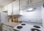Thumbnail 8 of 50 - close-up of the stove and white cabinets at Princeton Court, Dallas, Texas