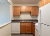 Thumbnail 16 of 78 - This is a photo of a kitchen with honey oak cabinets and white appliances in a 560 square foot 1, 1 bath apartment at Park Lane Apartments in Cincinnati, OH.