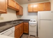 Thumbnail 15 of 78 - This is a photo of a kitchen with honey oak cabinets and white appliances in a 560 square foot 1, 1 bath apartment at Park Lane Apartments in Cincinnati, OH.