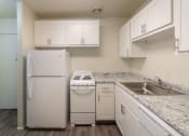 Thumbnail 11 of 78 - This is a photo of a kitchen with white cabinets and white appliances in a 560 square foot 1, 1 bath apartment at Park Lane Apartments in Cincinnati, OH.