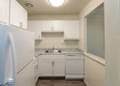 Thumbnail 8 of 78 - This is a photo of a kitchen with white cabinets and white appliances in a 560 square foot 1, 1 bath apartment at Park Lane Apartments in Cincinnati, OH.