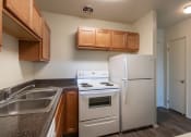 Thumbnail 3 of 78 - This is a photo of a kitchen with honey oak cabinets and white appliances in a 560 square foot 1, 1 bath apartment at Park Lane Apartments in Cincinnati, OH.