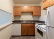 Thumbnail 1 of 78 - This is a photo of a kitchen with honey oak cabinets and white appliances in a 560 square foot 1, 1 bath apartment at Park Lane Apartments in Cincinnati, OH.