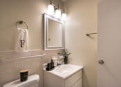 Thumbnail 26 of 38 - A white bathroom with a towel hung on the wall.