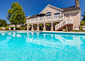 Thumbnail 56 of 96 - A house with a pool in front of it.