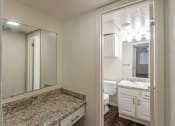 Thumbnail 21 of 34 - This is a photo of the vanity and bathroom in the 486 square foot 1 bedroom apartment at The Summit at Midtown Apartments in Dallas, TX.