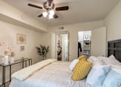 Thumbnail 13 of 43 - Bedroom with ceiling fan and access to the bathroom and closet area at The Summit at Midtown in Midtown Dallas