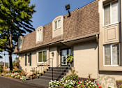 Thumbnail 50 of 60 - Leasing office exterior with front steps, flower beds, and landscaped entry at Village East Apartments