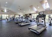 Thumbnail 48 of 75 - A gym with treadmills, elliptical machines, and other exercise equipment.