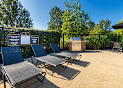 Thumbnail 45 of 75 - A sunny day at the pool with chairs and a signboard.