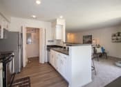 Thumbnail 24 of 57 - This is a photo of the kitchen and living room of the 1100 square foot 2 bedroom Kettering floor plan at Washington Park Apartments in Centerville, OH.