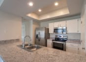 Thumbnail 4 of 57 - This is a photo of the kitchen of the 1500 square foot 3 bedroom, 2 and a half bath with 2-car garage Bellbrook floor plan at Washington Park Apartments in Centerville, OH.