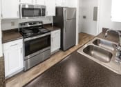 Thumbnail 11 of 57 - This is a photo of the kitchen of the 1100 square foot 2 bedroom, 2 bath Eaton floor plan at Washington Park Apartments in Centerville, OH.