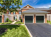Thumbnail 55 of 61 - A house with a green garage door in front.