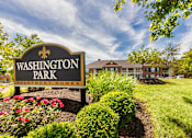 Thumbnail 59 of 61 - A sign for Washington Park Apartment Homes is shown in front of a building.
