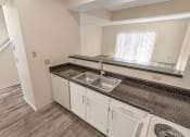 Thumbnail 9 of 57 - This is a photo of the kitchen of the 1280 square foot 2 bedroom, 2 and 1/2 bath Oakwood floor plan at Washington Park Apartments in Centerville, OH.