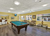 Thumbnail 9 of 19 - a game room with a pool table    and a bar at Olive Tree Apartments, Torrance, CA
