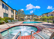Thumbnail 2 of 36 - our apartments have a large hot tub and a pool with chairs at Casa Del Amo Apartments, California, 90505
