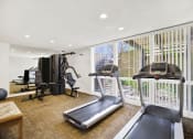 Thumbnail 14 of 36 - a gym with exercise equipment and a large window at Casa Del Amo Apartments, California, 90505