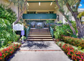 Thumbnail 5 of 54 - the steps up to the front of a building with plants and flowers at Camino de Oro Apartments, Torrance, CA, 90505