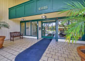 Thumbnail 7 of 54 - the entrance to a building with glass doors and a rug at Camino de Oro Apartments, California, 90505