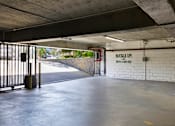 Thumbnail 54 of 54 - the inside of a parking garage with a gate at Camino de Oro Apartments, Torrance, CA, 90505