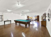 Thumbnail 14 of 54 - a room with a pool table in the middle of it at Camino de Oro Apartments, Torrance, California