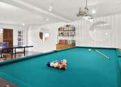 Thumbnail 15 of 54 - a pool table in a room with balls on it at Camino de Oro Apartments, Torrance, CA