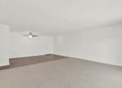 Thumbnail 45 of 54 - the spacious living room with white walls and a ceiling fan at Camino de Oro Apartments, Torrance, California