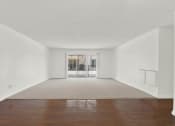 Thumbnail 35 of 54 - an empty living room with a hard wood floor and a balcony at Camino de Oro Apartments, Torrance, CA, 90505
