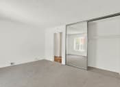 Thumbnail 36 of 54 - an empty living room with a sliding glass door to a closet at Camino de Oro Apartments, Torrance, CA, 90505